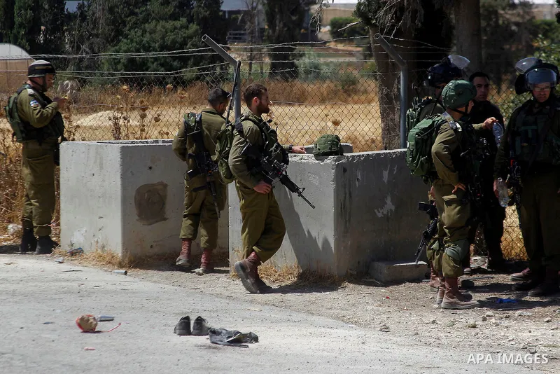 Israeli soldiers are seen at the site of a stabbing attack by a Palestinian man next to the entrance of the al-Arub refugee camp near the city of Hebron in the Israeli-occupied West Bank on July 18, 2016 in which two sol...