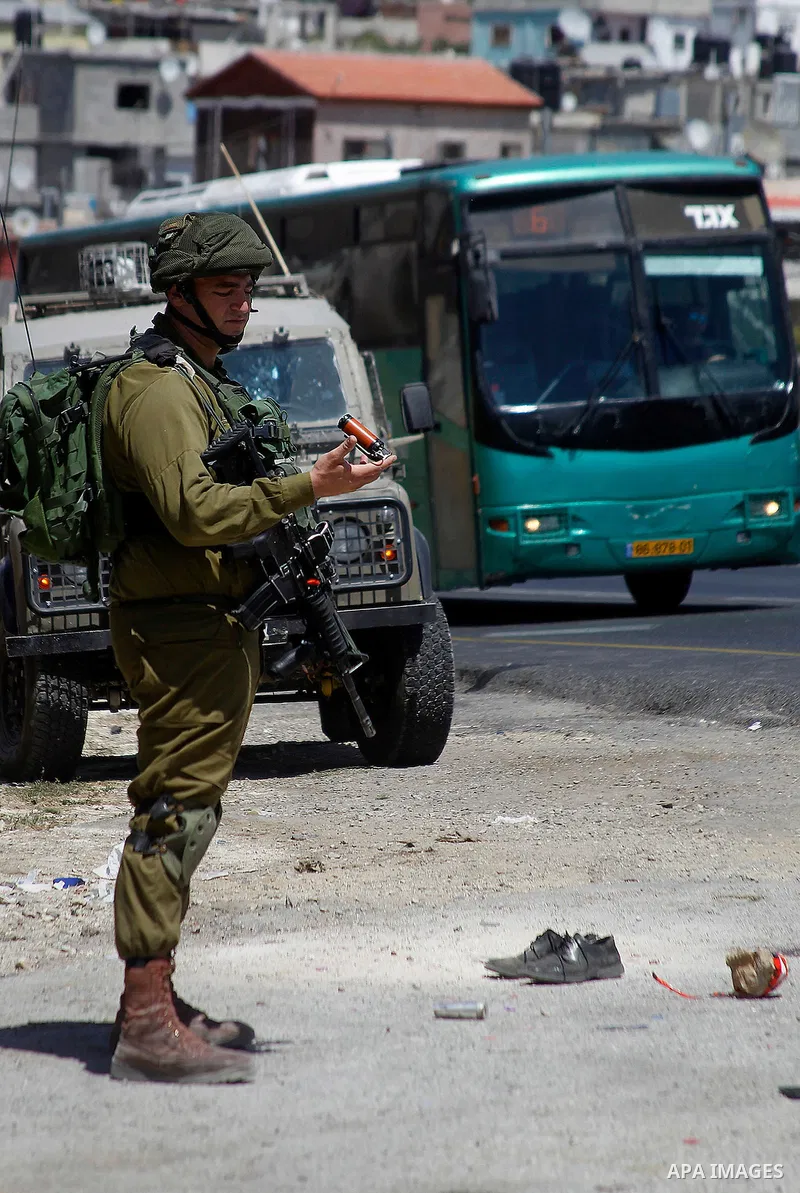 Israeli soldiers are seen at the site of a stabbing attack by a Palestinian man next to the entrance of the al-Arub refugee camp near the city of Hebron in the Israeli-occupied West Bank on July 18, 2016 in which two sol...