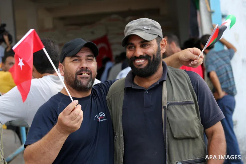Palestinians receive Turkish aid at an aid distribution centre in Gaza city, on July 19, 2016. The aid, consisting of flour, sugar and rice, was allowed into the Palestinian territory via Israel’s Kerem Shalom crossing a...