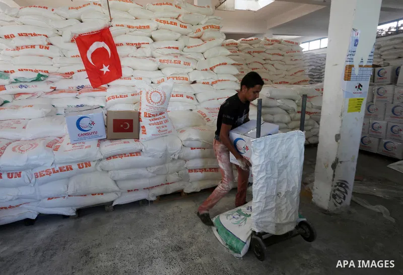 Palestinians receive Turkish aid at an aid distribution centre in Gaza city, on July 19, 2016. The aid, consisting of flour, sugar and rice, was allowed into the Palestinian territory via Israel’s Kerem Shalom crossing a...