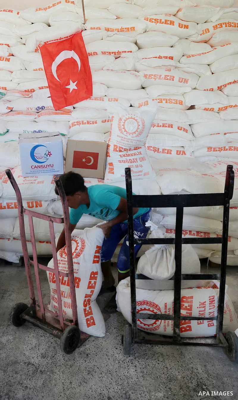 Palestinians receive Turkish aid at an aid distribution centre in Gaza city, on July 19, 2016. The aid, consisting of flour, sugar and rice, was allowed into the Palestinian territory via Israel’s Kerem Shalom crossing a...