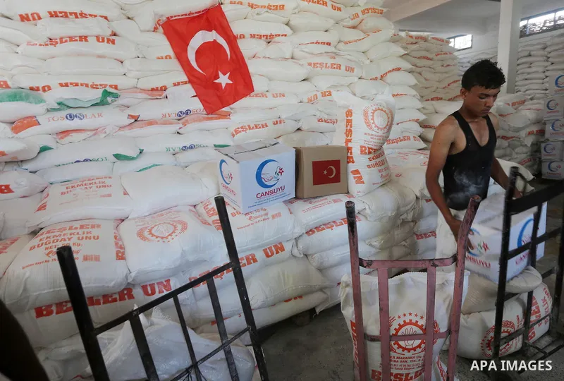 Palestinians receive Turkish aid at an aid distribution centre in Gaza city, on July 19, 2016. The aid, consisting of flour, sugar and rice, was allowed into the Palestinian territory via Israel’s Kerem Shalom crossing a...