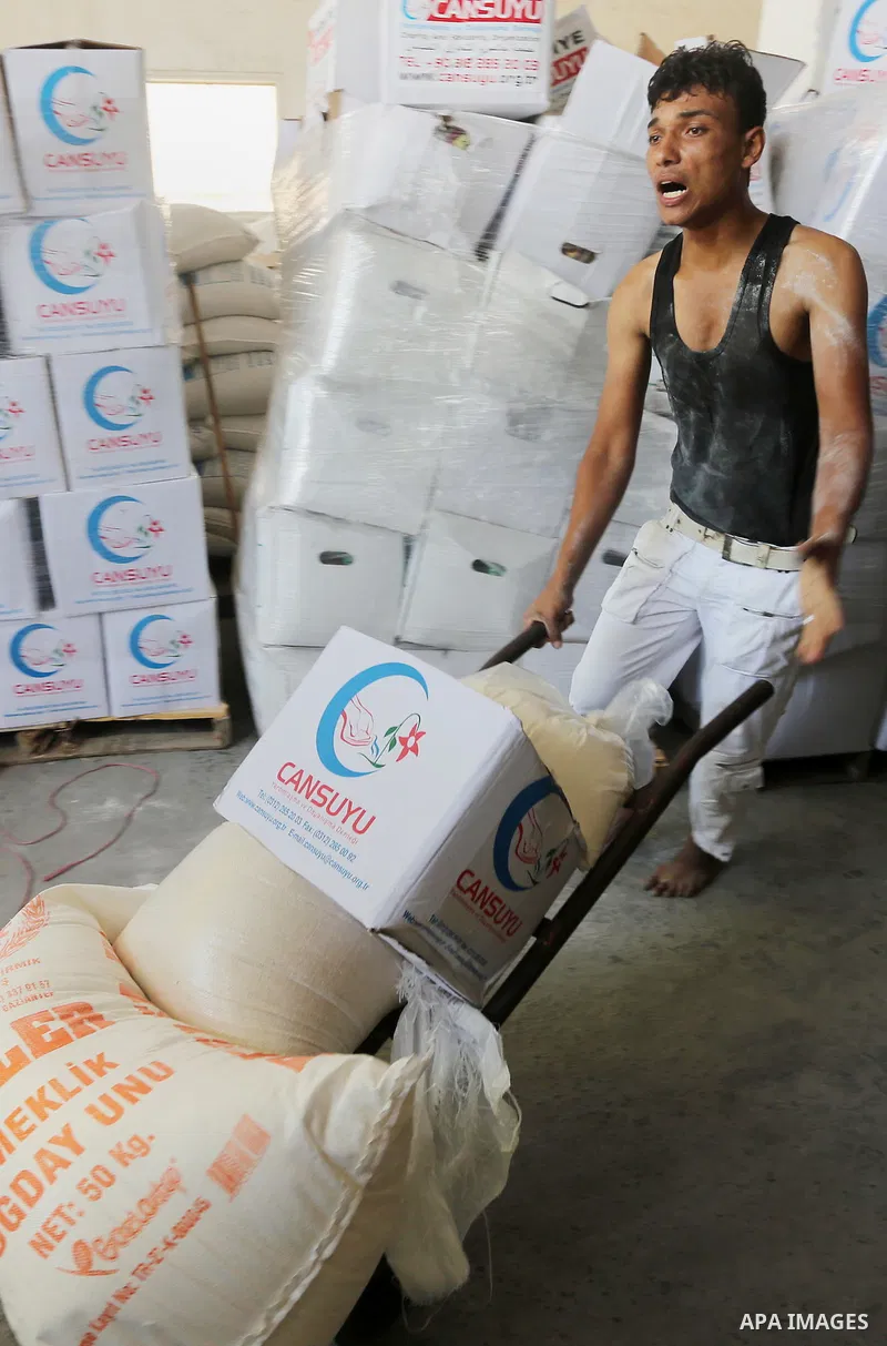 Palestinians receive Turkish aid at an aid distribution centre in Gaza city, on July 19, 2016. The aid, consisting of flour, sugar and rice, was allowed into the Palestinian territory via Israel’s Kerem Shalom crossing a...