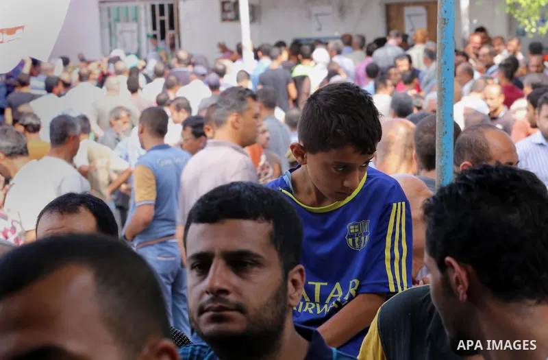 Palestinians receive Turkish aid at an aid distribution centre in Gaza city, on July 19, 2016. The aid, consisting of flour, sugar and rice, was allowed into the Palestinian territory via Israel’s Kerem Shalom crossing a...