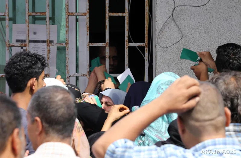 Palestinians receive Turkish aid at an aid distribution centre in Gaza city, on July 19, 2016. The aid, consisting of flour, sugar and rice, was allowed into the Palestinian territory via Israel’s Kerem Shalom crossing a...