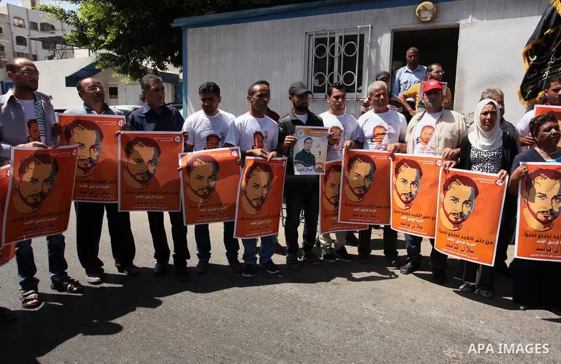 Palestinians take part in a protest calling for the release of Bilal Kayed a Palestinian prisoner on hunger strike in front of the high commissioner for human rights headquarters in Gaza City, on June 19, 2016. Photo by...