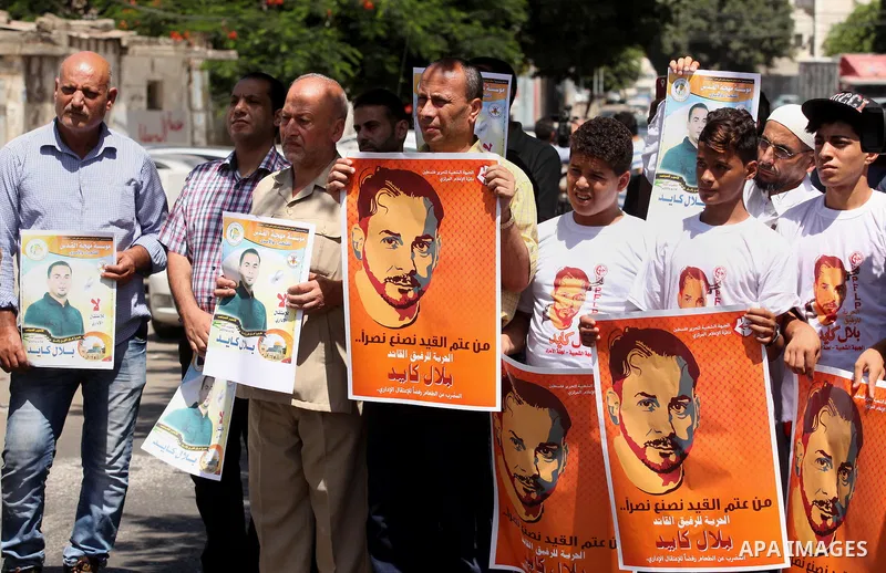Palestinians take part in a protest calling for the release of Bilal Kayed a Palestinian prisoner on hunger strike in front of the high commissioner for human rights headquarters in Gaza City, on June 19, 2016. Photo by...
