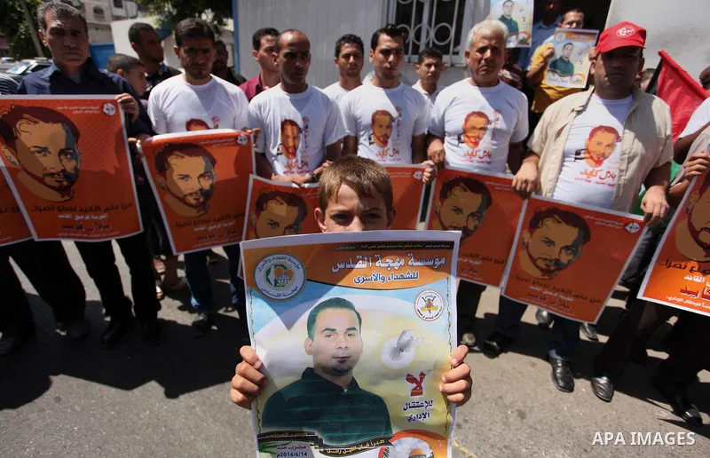 Palestinians take part in a protest calling for the release of Bilal Kayed a Palestinian prisoner on hunger strike in front of the high commissioner for human rights headquarters in Gaza City, on June 19, 2016. Photo by...