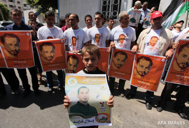 Palestinians take part in a protest calling for the release of Bilal Kayed a Palestinian prisoner on hunger strike in front of the high commissioner for human rights headquarters in Gaza City, on June 19, 2016. Photo by...