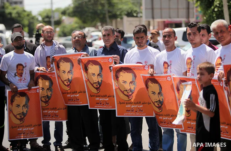 Palestinians take part in a protest calling for the release of Bilal Kayed a Palestinian prisoner on hunger strike in front of the high commissioner for human rights headquarters in Gaza City, on June 19, 2016. Photo by...