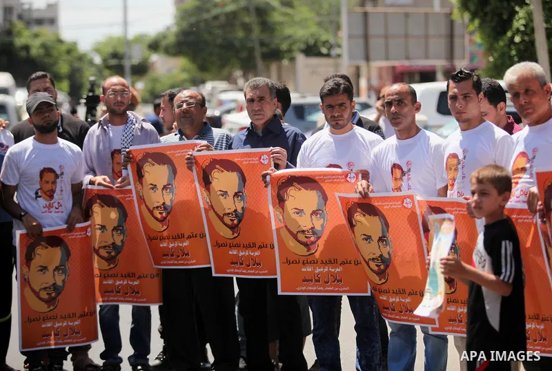 Palestinians take part in a protest calling for the release of Bilal Kayed a Palestinian prisoner on hunger strike in front of the high commissioner for human rights headquarters in Gaza City, on June 19, 2016. Photo by...