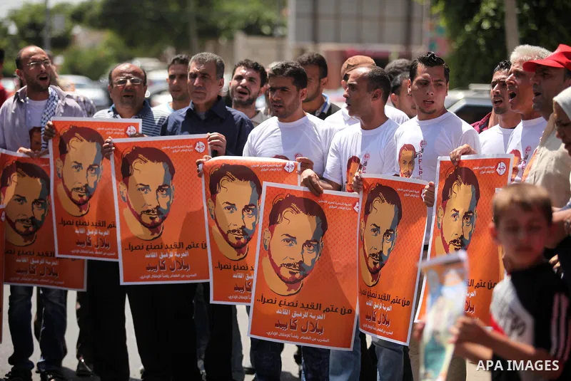Palestinians take part in a protest calling for the release of Bilal Kayed a Palestinian prisoner on hunger strike in front of the high commissioner for human rights headquarters in Gaza City, on June 19, 2016. Photo by...