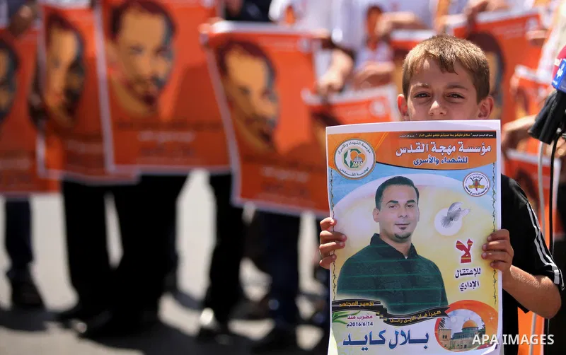 Palestinians take part in a protest calling for the release of Bilal Kayed a Palestinian prisoner on hunger strike in front of the high commissioner for human rights headquarters in Gaza City, on June 19, 2016. Photo by...