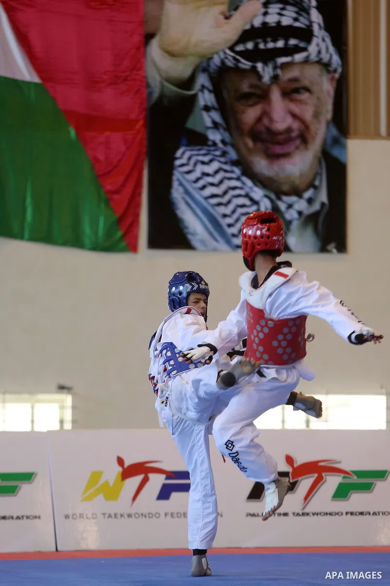 Taekwondo fighters spar during the International Taekwondo Championships at the Birzeit University in the West Bank city of Ramallah on July 19, 2016. Foreign football teams have already played matches in the Palestinian...