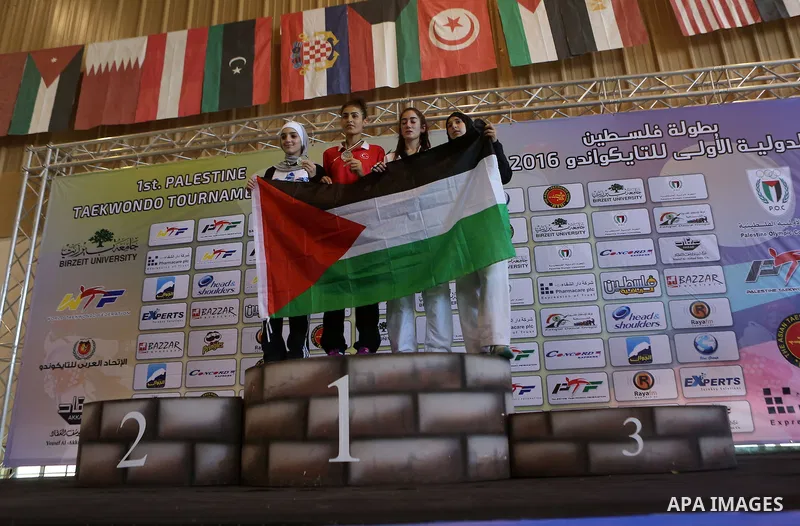 Female taekwondo competitors pose for a photo during the International Taekwondo Championships at the Birzeit University in the West Bank city of Ramallah on July 19, 2016. Foreign football teams have already played matc...