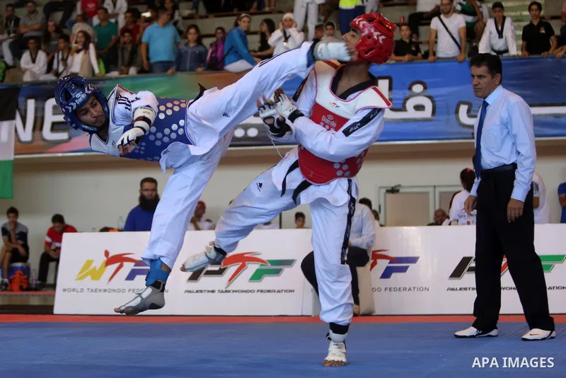 Taekwondo fighters spar during the International Taekwondo Championships at the Birzeit University in the West Bank city of Ramallah on July 19, 2016. Foreign football teams have already played matches in the Palestinian...
