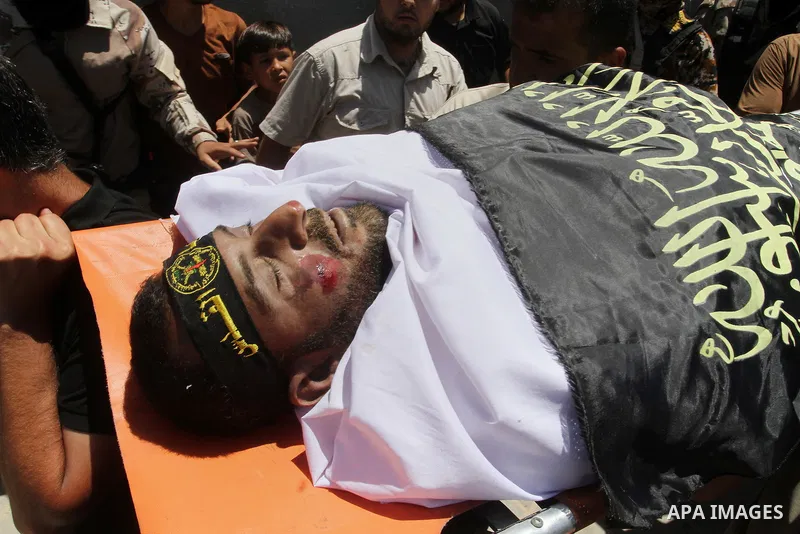 Palestinian members of the Islamic Jihad's armed wing, the Al-Quds Brigades, carry the body of a fellow militant, Salah al-Astal, who died after a tunnel collapse in the Gaza Strip, during his funeral in Khan Younis in t...