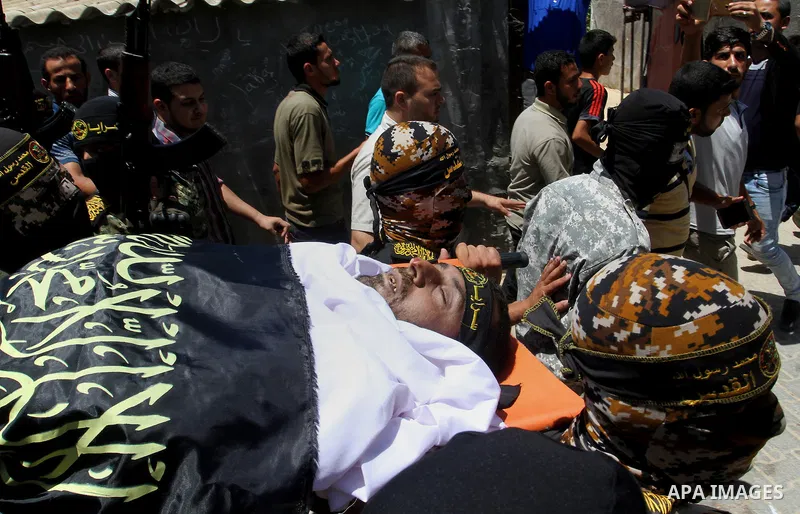 Palestinian members of the Islamic Jihad's armed wing, the Al-Quds Brigades, carry the body of a fellow militant, Salah al-Astal, who died after a tunnel collapse in the Gaza Strip, during his funeral in Khan Younis in t...