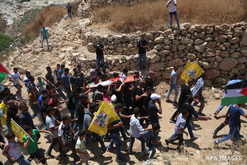 Palestinian carry the body of Muhey al-Tabakhi, 12, who was killed on Tuesday during a clash with Israeli troops, during his funeral in the West Bank town of Al-Ram, near Jerusalem July 20, 2016. Photo by Shadi Hatem