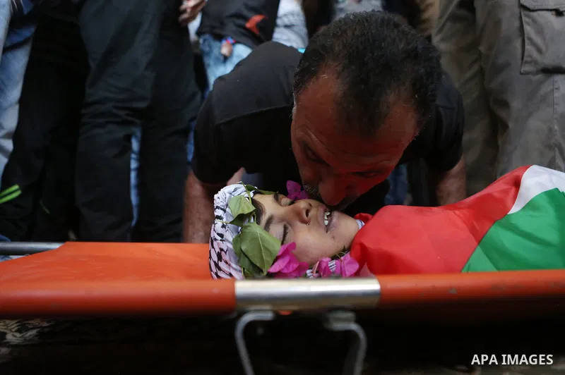 Palestinian carry the body of Muhey al-Tabakhi, 12, who was killed on Tuesday during a clash with Israeli troops, during his funeral in the West Bank town of Al-Ram, near Jerusalem July 20, 2016. Photo by Shadi Hatem