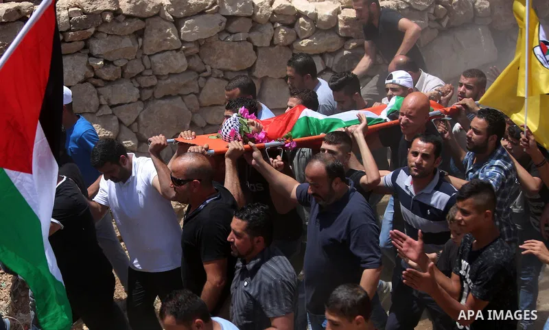 Palestinian carry the body of Muhey al-Tabakhi, 12, who was killed on Tuesday during a clash with Israeli troops, during his funeral in the West Bank town of Al-Ram, near Jerusalem July 20, 2016. Photo by Shadi Hatem