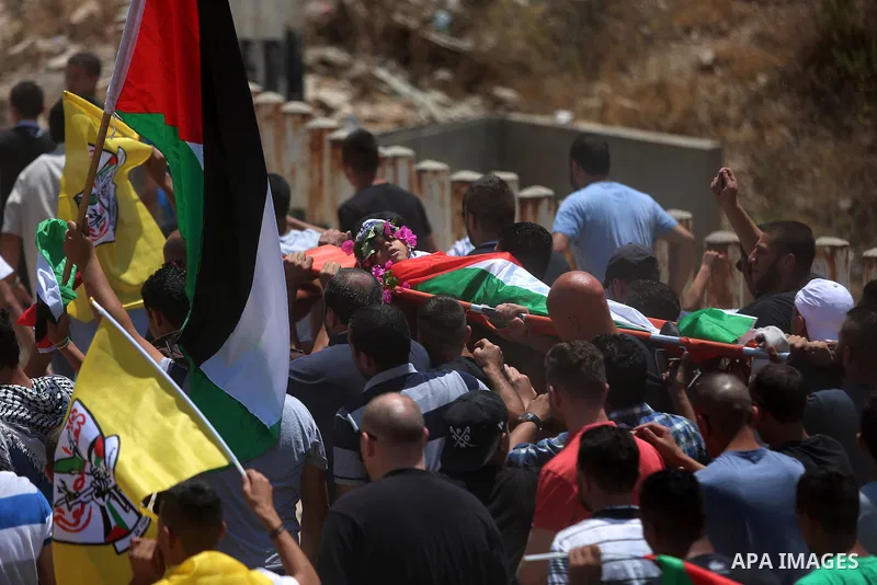 Palestinian carry the body of Muhey al-Tabakhi, 12, who was killed on Tuesday during a clash with Israeli troops, during his funeral in the West Bank town of Al-Ram, near Jerusalem July 20, 2016. Photo by Shadi Hatem
