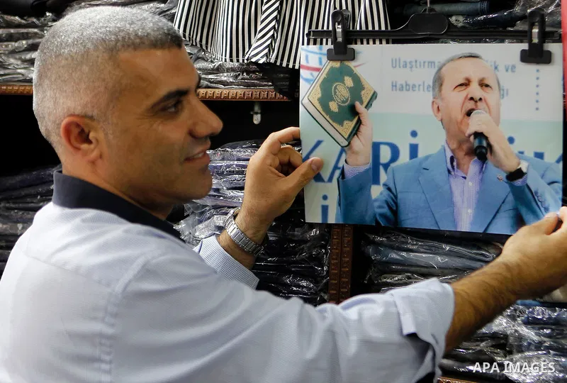 Palestinians hold portraits of Turkish President Recep Tayyip Erdogan during a protest against the military coup attempt in Turkey in the West bank city of Hebron 20 July 2016. Photo by Wisam Hashlamoun