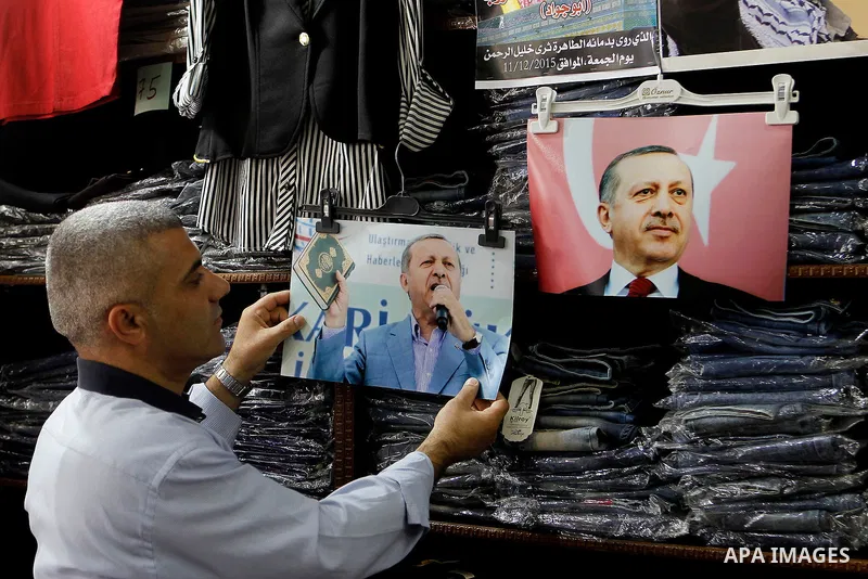 Palestinians hold portraits of Turkish President Recep Tayyip Erdogan during a protest against the military coup attempt in Turkey in the West bank city of Hebron 20 July 2016. Photo by Wisam Hashlamoun