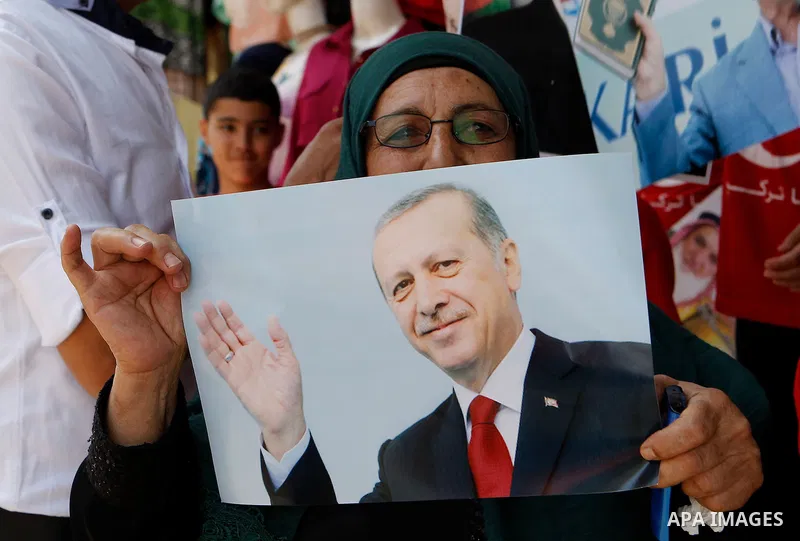 Palestinians hold portraits of Turkish President Recep Tayyip Erdogan during a protest against the military coup attempt in Turkey in the West bank city of Hebron 20 July 2016. Photo by Wisam Hashlamoun