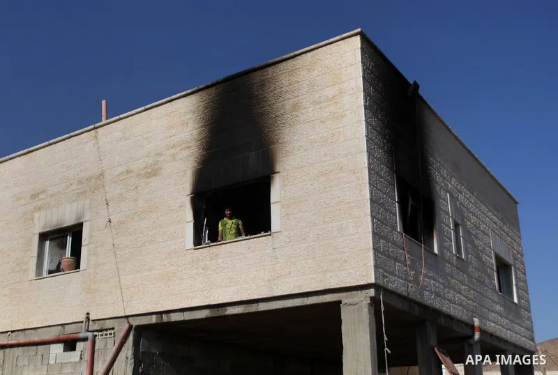 Palestinians inspect a damaged house following a blaze overnight in the village of Duma in the Israeli-occupied West Bank on July 20, 2016. The house is located in the Palestinian village where an arson attack by Jewish...