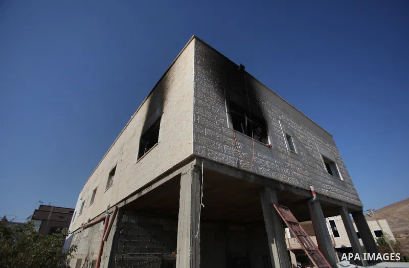 Palestinians inspect a damaged house following a blaze overnight in the village of Duma in the Israeli-occupied West Bank on July 20, 2016. The house is located in the Palestinian village where an arson attack by Jewish...