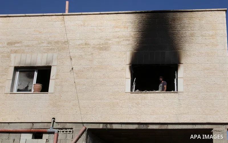 Palestinians inspect a damaged house following a blaze overnight in the village of Duma in the Israeli-occupied West Bank on July 20, 2016. The house is located in the Palestinian village where an arson attack by Jewish...