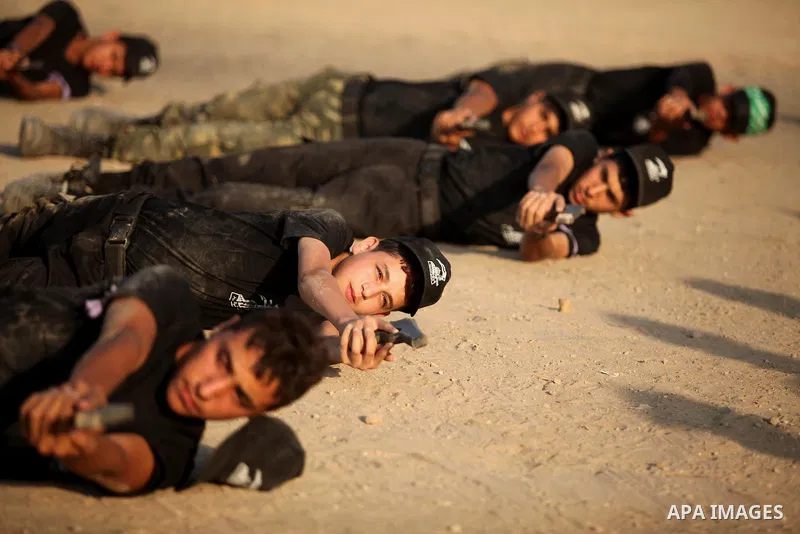 Palestinian youths demonstrate their skills during a military-style exercise at the Liberation Youths summer camp, organised by the Hamas movement, in Gaza city on July 20, 2016. Photo by Ashraf Amra