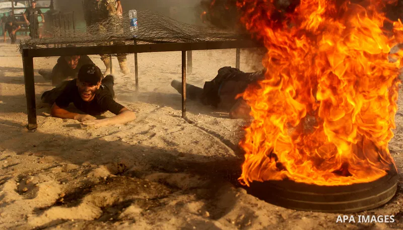 Palestinian youths demonstrate their skills during a military-style exercise at the Liberation Youths summer camp, organised by the Hamas movement, in Gaza city on July 20, 2016. Photo by Ashraf Amra