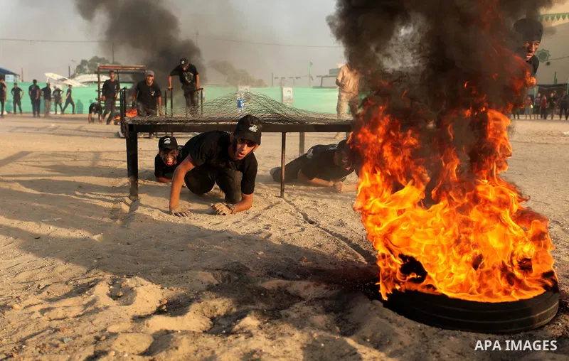 Palestinian youths demonstrate their skills during a military-style exercise at the Liberation Youths summer camp, organised by the Hamas movement, in Gaza city on July 20, 2016. Photo by Ashraf Amra