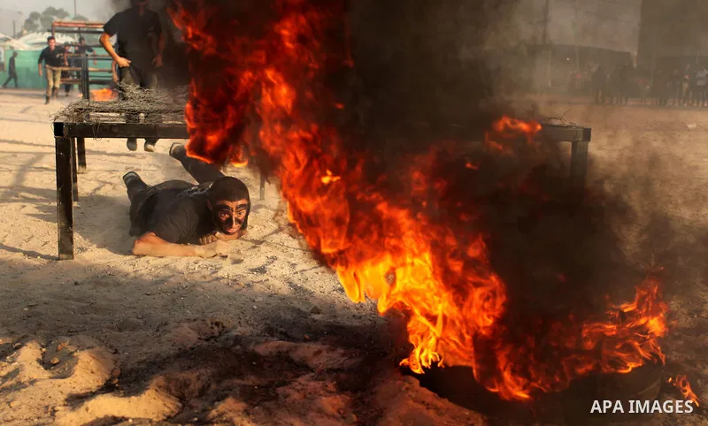 Palestinian youths demonstrate their skills during a military-style exercise at the Liberation Youths summer camp, organised by the Hamas movement, in Gaza city on July 20, 2016. Photo by Ashraf Amra