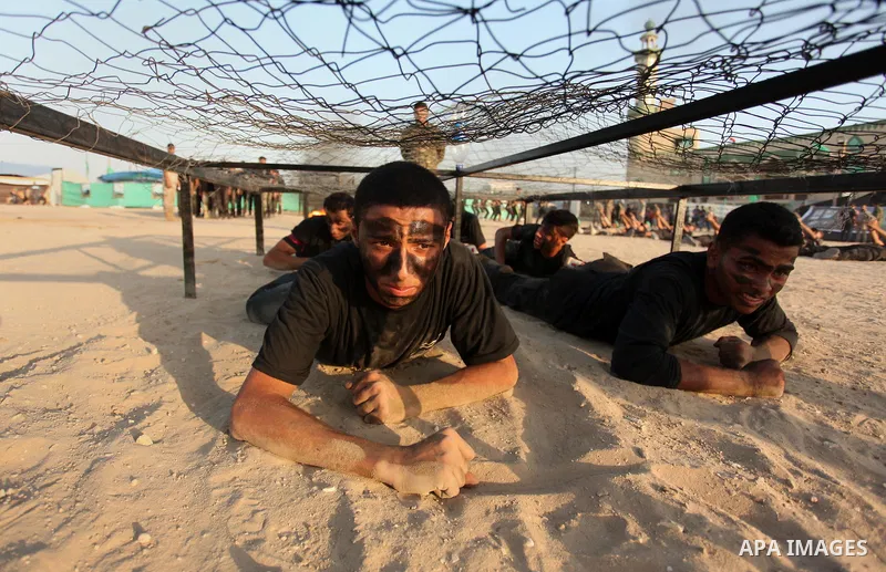 Palestinian youths demonstrate their skills during a military-style exercise at the Liberation Youths summer camp, organised by the Hamas movement, in Gaza city on July 20, 2016. Photo by Ashraf Amra