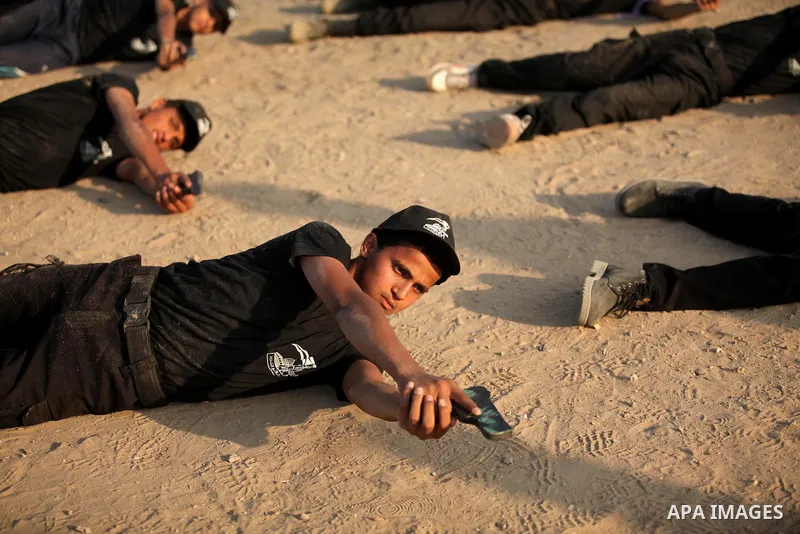 Palestinian youths demonstrate their skills during a military-style exercise at the Liberation Youths summer camp, organised by the Hamas movement, in Gaza city on July 20, 2016. Photo by Ashraf Amra