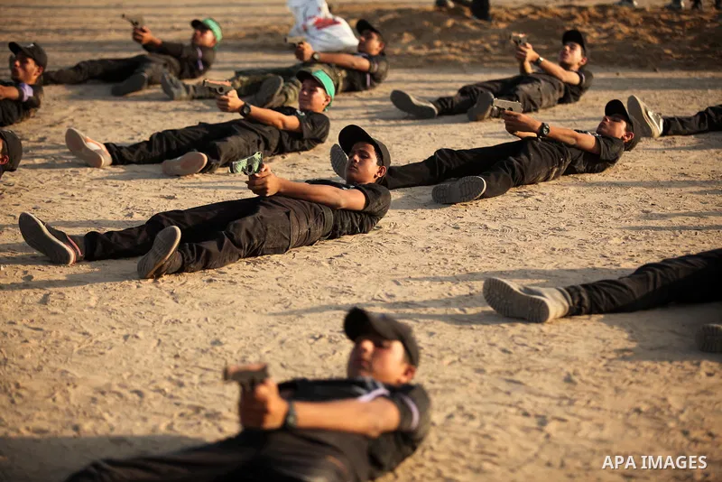 Palestinian youths demonstrate their skills during a military-style exercise at the Liberation Youths summer camp, organised by the Hamas movement, in Gaza city on July 20, 2016. Photo by Ashraf Amra