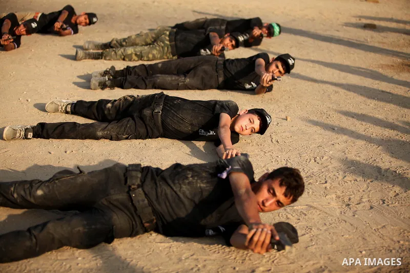 Palestinian youths demonstrate their skills during a military-style exercise at the Liberation Youths summer camp, organised by the Hamas movement, in Gaza city on July 20, 2016. Photo by Ashraf Amra