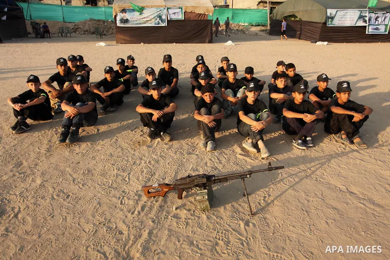 Palestinian youths take part in a military-style exercise at the Liberation Youths summer camp, organised by the Hamas movement, in Gaza city on July 20, 2016. Photo by Ashraf Amra