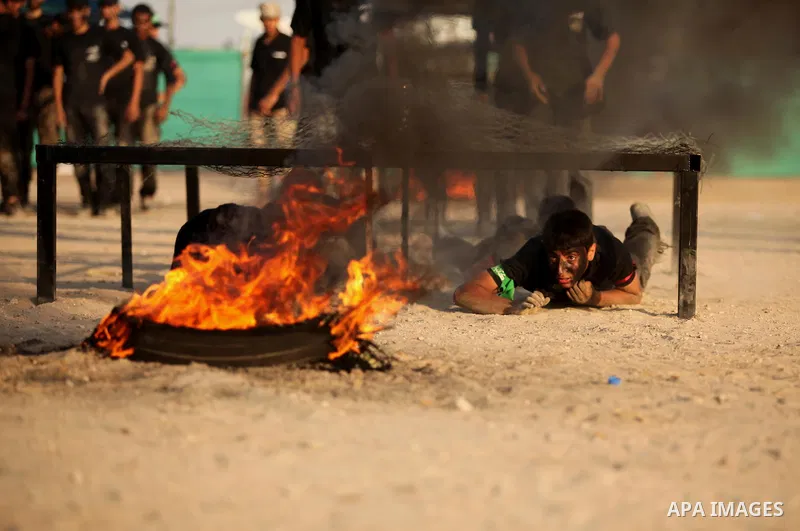 Palestinian youths demonstrate their skills during a military-style exercise at the Liberation Youths summer camp, organised by the Hamas movement, in Gaza city on July 20, 2016. Photo by Ashraf Amra