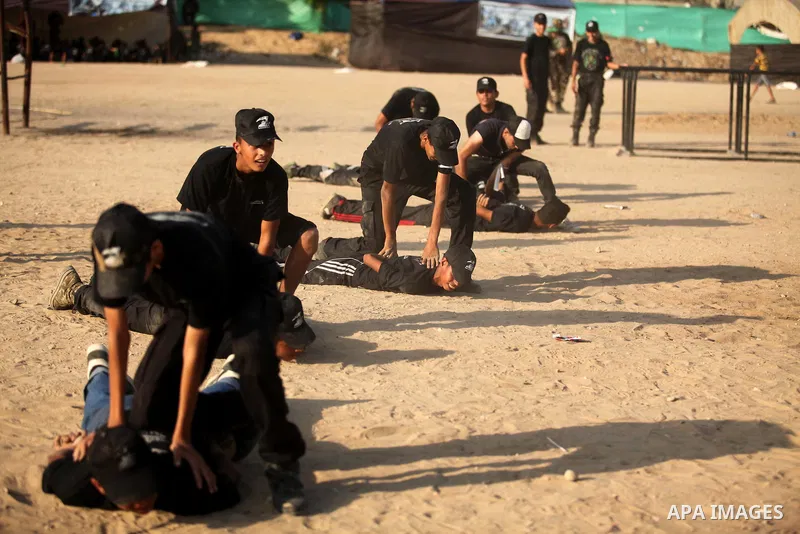 Palestinian youths demonstrate their skills during a military-style exercise at the Liberation Youths summer camp, organised by the Hamas movement, in Gaza city on July 20, 2016. Photo by Ashraf Amra