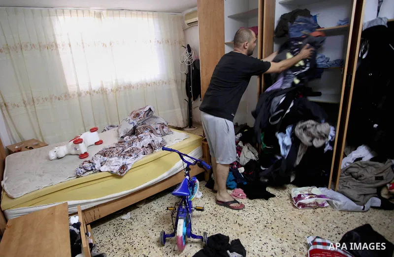 Palestinians inspect their room after the Israeli soldiers raided their family house, at Kafr Qalil village near the West Bank city of Nablus, on July 21, 2016. Photo by Nedal Eshtayah