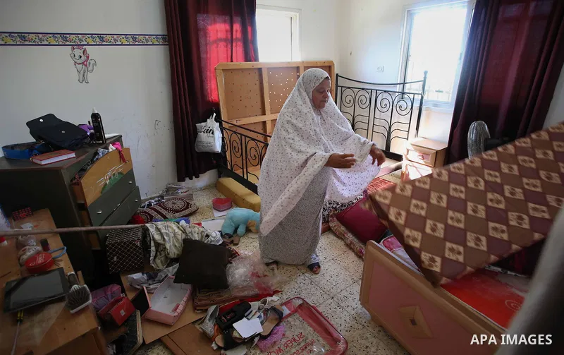 Palestinians inspect their room after the Israeli soldiers raided their family house, at Kafr Qalil village near the West Bank city of Nablus, on July 21, 2016. Photo by Nedal Eshtayah