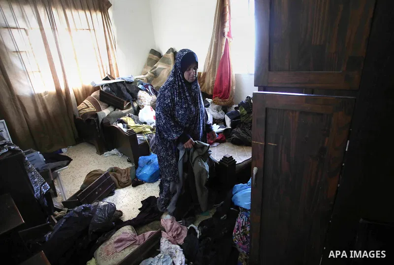 Palestinians inspect their room after the Israeli soldiers raided their family house, at Kafr Qalil village near the West Bank city of Nablus, on July 21, 2016. Photo by Nedal Eshtayah