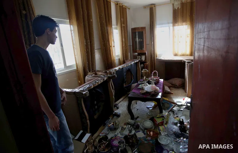 Palestinians inspect their room after the Israeli soldiers raided their family house, at Kafr Qalil village near the West Bank city of Nablus, on July 21, 2016. Photo by Nedal Eshtayah