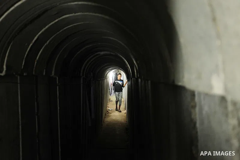 Palestinians walk inside a tunnel used for military exercises during a weapon exhibition at a Hamas-run youth summer camp, in Gaza City, on July 21, 2016. Photo by Ashraf Amra