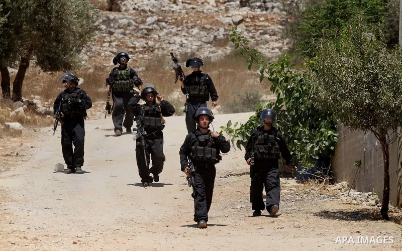 Israeli security forces aim looks towards Palestinian protestors during clashes following the weekly demonstration against the expropriation of Palestinian land by Israel in the village of Kfar Qaddum, near Nablus, in th...