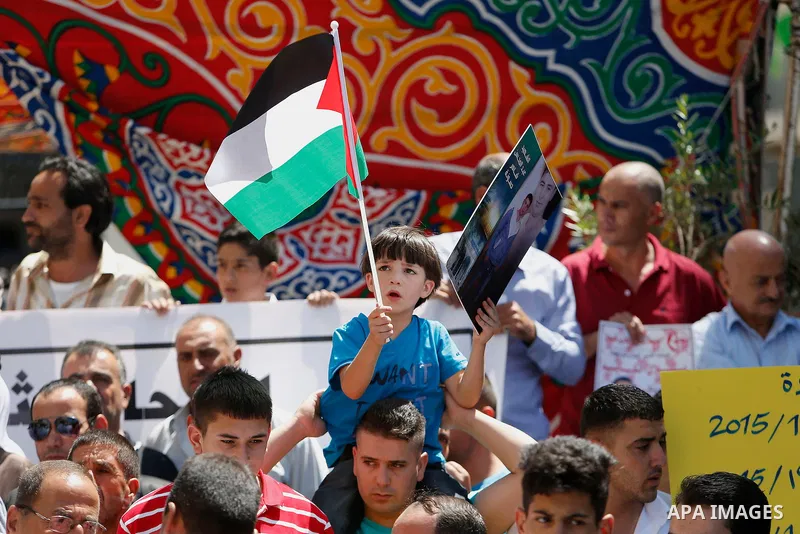 Palestinians hold placards during a protest in the West Bank city of Hebron 23 July 2016. Palestinians from all over the West bank held protest to support Palestinians prisoners Bilal Kayyed and Mohammad and Mahmoud Balb...